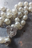 Beautiful one of a kind pearl and vintage silver wedding rosary with a stunning vintage silver ornate Pardon Crucifix. Kim Williams Patenôtrier Rosaries, The Village Artist, Proudly South African, handmade. Catholic Store South African.