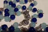 Pope John Paull II Papal crucifix handmade rosary, sapphire and ice blue glass beads, vintage metal roses, Madonna and child center piece, the village artist, one-of-a-kind handmade rosaries, Patenôtrier,  South African artist and jeweler.
