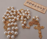 Beautiful one of a kind ivory pearl beads with gold filigree bead caps. Gold disc shaped St benedict beads. Detailed Loretta fleur de Lis gold crucifix. Kim Williams Patenôtrier Rosaries, The Village Artist, Proudly South African, handmade. Catholic Store South African.