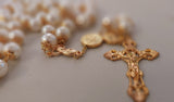 Beautiful one of a kind ivory pearl beads with gold filigree bead caps. Gold disc shaped St benedict beads. Detailed Loretta fleur de Lis gold crucifix. Kim Williams Patenôtrier Rosaries, The Village Artist, Proudly South African, handmade. Catholic Store South African.