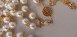 Beautiful one of a kind ivory pearl beads with gold filigree bead caps. Gold disc shaped St benedict beads. Detailed Loretta fleur de Lis gold crucifix. Kim Williams Patenôtrier Rosaries, The Village Artist, Proudly South African, handmade. Catholic Store South African.