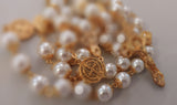 Beautiful one of a kind ivory pearl beads with gold filigree bead caps. Gold disc shaped St benedict beads. Detailed Loretta fleur de Lis gold crucifix. Kim Williams Patenôtrier Rosaries, The Village Artist, Proudly South African, handmade. Catholic Store South African.
