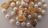 Beautiful one of a kind ivory pearl beads with gold filigree bead caps. Gold disc shaped St benedict beads. Detailed Loretta fleur de Lis gold crucifix. Kim Williams Patenôtrier Rosaries, The Village Artist, Proudly South African, handmade. Catholic Store South African.