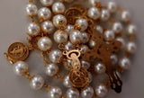 Beautiful one of a kind ivory pearl beads with gold filigree bead caps. Gold disc shaped St benedict beads. Detailed Loretta fleur de Lis gold crucifix. Kim Williams Patenôtrier Rosaries, The Village Artist, Proudly South African, handmade. Catholic Store South African.
