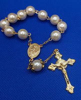 Beautiful Gold Catholic Baptism Rosary. 1 decade. 11 vintage ivory smooth round glass faux pearl beads. Gold links and chains. Vintage gold ornate flower beads caps.  Ornate detailed sun crucifix. Our Holy Family center piece on back and with the Holy Spirit Dove on the front in gold. Kim Williams Rosaries. The Village Artist. 