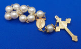 Beautiful Gold Catholic Baptism Rosary. 1 decade. 11 vintage ivory smooth round glass faux pearl beads. Gold links and chains. Vintage gold ornate flower beads caps.  Ornate detailed sun crucifix. Our Holy Family center piece on back and with the Holy Spirit Dove on the front in gold. Kim Williams Rosaries. The Village Artist. 