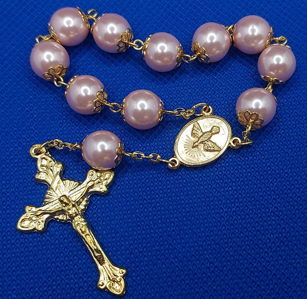 Beautiful Gold Catholic Baptism Rosary. 1 decade. 11 vintage ivory smooth round glass faux pearl beads. Gold links and chains. Vintage gold ornate flower beads caps.  Ornate detailed sun crucifix. Our Holy Family center piece on back and with the Holy Spirit Dove on the front in gold. Kim Williams Rosaries. The Village Artist. 