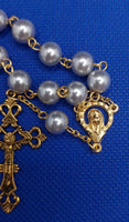 Beautiful Gold Catholic Baptism Rosary. 1 decade. 11 smooth round glass faux vintage silver pearl beads. Gold links and chains. Ornate detailed Loretta crucifix. Our Lady of 12 stars crown with Sacred Heart in gold on the back. Kim Williams Rosaries. The Village Artist. 