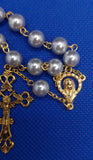 Beautiful Gold Catholic Baptism Rosary. 1 decade. 11 smooth round glass faux vintage silver pearl beads. Gold links and chains. Ornate detailed Loretta crucifix. Our Lady of 12 stars crown with Sacred Heart in gold on the back. Kim Williams Rosaries. The Village Artist. 