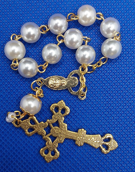 Beautiful Gold Catholic Baptism Rosary. 1 decade. 11 vintage ivory smooth round glass faux pearl beads. Gold links and chains. Vintage gold flower beads caps. Ornate detailed Loretta crucifix. Virgin Mary Praying center piece crowned with 12 stars center piece on the front and on the back the Immaculate Heart of Jesus in gold. Kim Williams Rosaries. The Village Artist. 