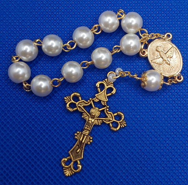 Beautiful Gold Catholic Baptism Rosary. 1 decade. 11 vintage ivory smooth round glass faux pearl beads. Gold links and chains. Ornate detailed Loretta crucifix. Our Holy Family center piece on back and with the Holy Spirit Dove on the front in gold.  Kim Williams Rosaries. The Village Artist.