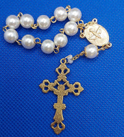 Beautiful Gold Catholic Baptism Rosary. 1 decade. 11 vintage ivory smooth round glass faux pearl beads. Gold links and chains. Ornate detailed Loretta crucifix. Our Holy Family center piece on back and with the Holy Spirit Dove on the front in gold.  Kim Williams Rosaries. The Village Artist.