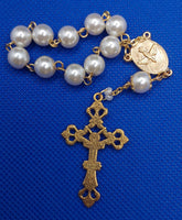 Beautiful Gold Catholic Baptism Rosary. 1 decade. 11 vintage ivory smooth round glass faux pearl beads. Gold links and chains. Ornate detailed Loretta crucifix. Our Holy Family center piece on back and with the Holy Spirit Dove on the front in gold.  Kim Williams Rosaries. The Village Artist.