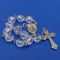 Beautiful silver Catholic Baptism Rosary. 1 decade. 11  round crystal cut round acrylic beads. silver links and chains.  Ornate detailed double sided Fatima crucifix. This crucifix  has grapes and leaves on the 4 ends of the cross reminding a person of the words of Christ, “I am the vine.” Our Miraculous medal  center piece in vintage silver. Kim Williams Rosaries. The Village Artist.