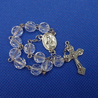 Beautiful silver Catholic Baptism Rosary. 1 decade. 11  round crystal cut round acrylic beads. silver links and chains.  Ornate detailed double sided Fatima crucifix. This crucifix  has grapes and leaves on the 4 ends of the cross reminding a person of the words of Christ, “I am the vine.” Our Miraculous medal  center piece in vintage silver. Kim Williams Rosaries. The Village Artist.