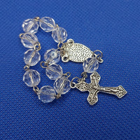 Beautiful silver Catholic Baptism Rosary. 1 decade. 11  round crystal cut round acrylic beads. silver links and chains.  Ornate detailed double sided Fatima crucifix. This crucifix  has grapes and leaves on the 4 ends of the cross reminding a person of the words of Christ, “I am the vine.” Our Miraculous medal  center piece in vintage silver. Kim Williams Rosaries. The Village Artist.