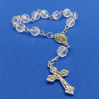 Beautiful silver Catholic Baptism Rosary. 1 decade. 11  round crystal cut round acrylic beads. silver links and chains.  Ornate detailed double sided Fatima crucifix. This crucifix  has grapes and leaves on the 4 ends of the cross reminding a person of the words of Christ, “I am the vine.” Our Miraculous medal  center piece in vintage silver. Kim Williams Rosaries. The Village Artist.